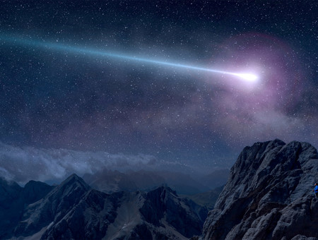 A purple shooting star at night over the mountain range