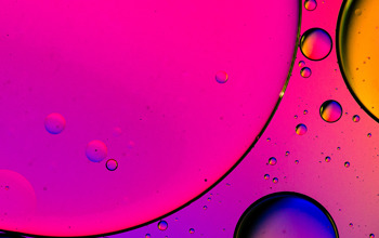 Abstract image of blue and pink bubbles as if looked through a microscope